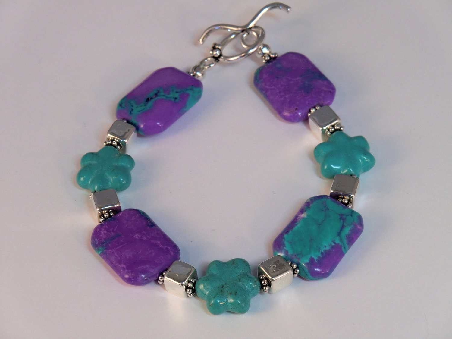 Purple and turquoise magnesite rectangular beaded bracelet with turquoise flower beads and Greek metalized silver cubes