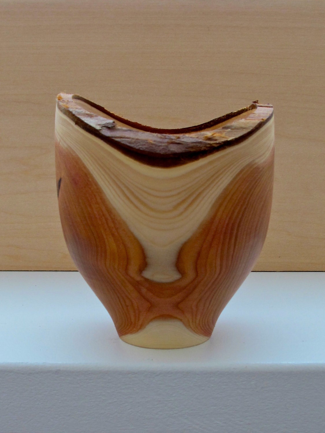 Hand turned yew-wood vessel with contrasting bark rim