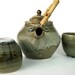 Teapot and tea bowls set with bamboo handle in olive green celedon