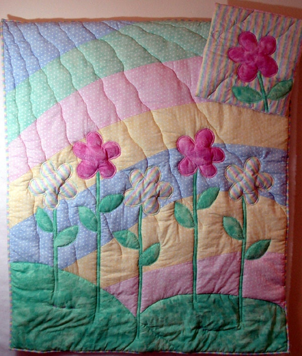 Child sized rainbow and  appliqued flower quilt with matching 14 inch flower pillow.