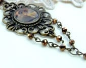 Victorian necklace with a cherub pendant and copper toned crystals