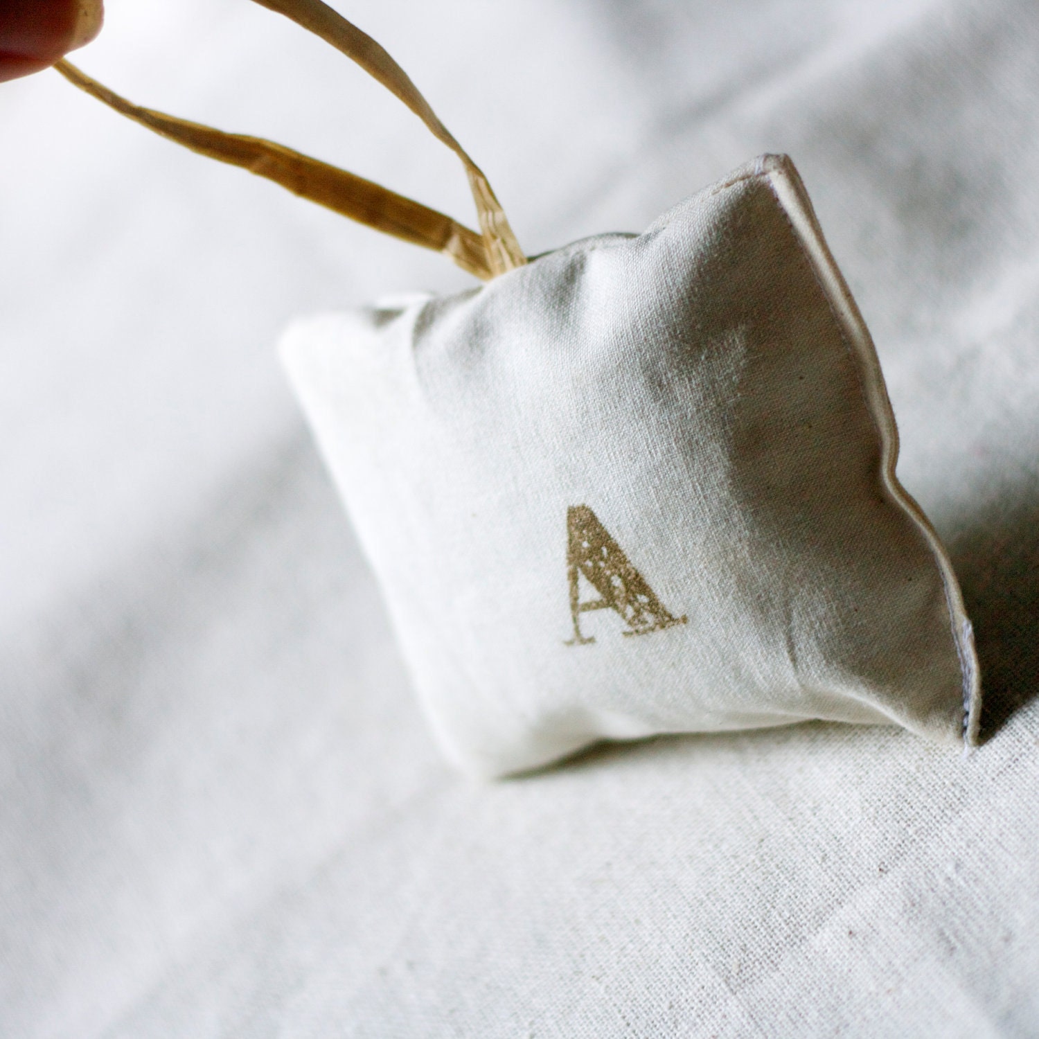 personalized lavender pillow ornament chocolate brown fancy lettering on cream linen with hang tag for your bedroom dresser table