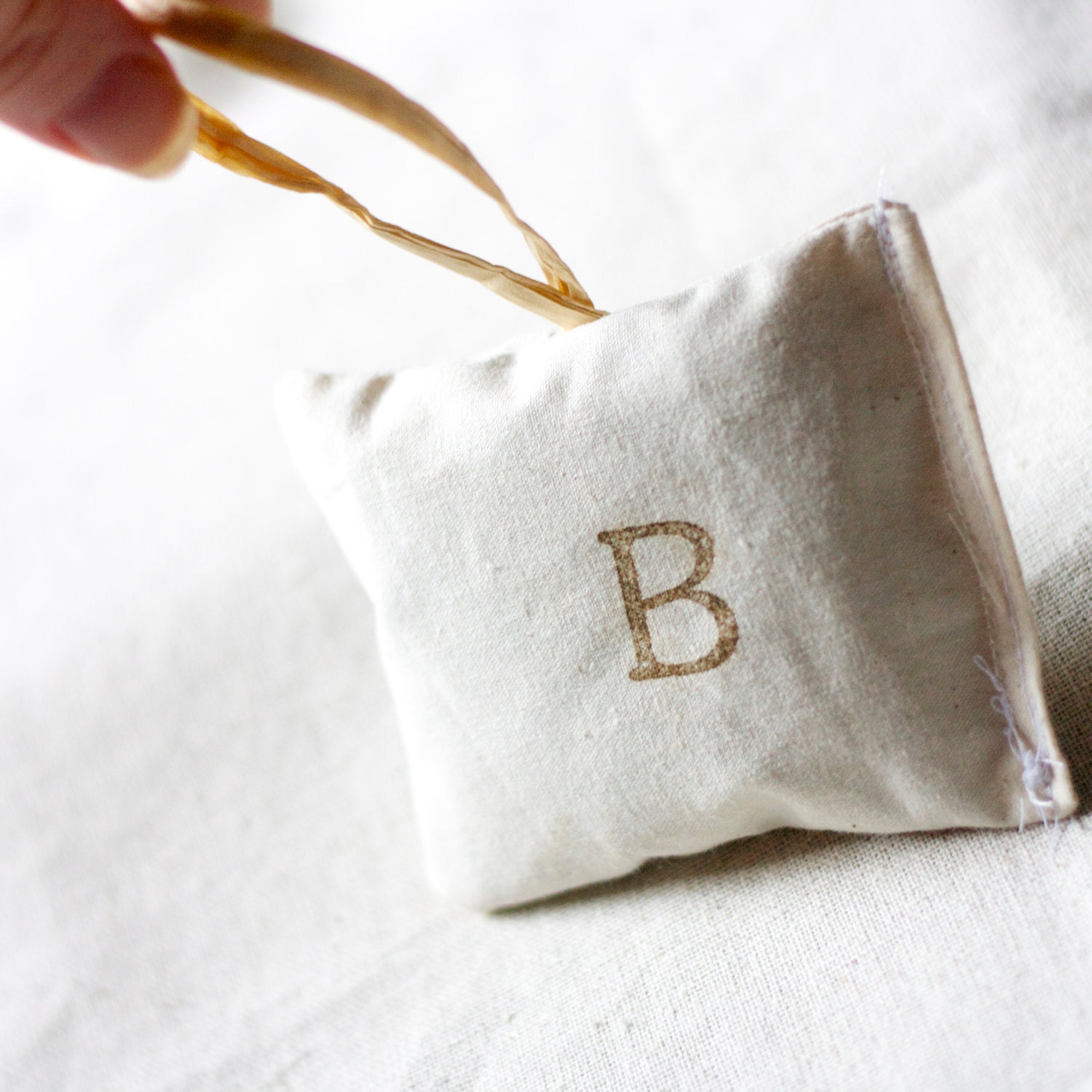 personalized lavender pillow ornament chocolate brown block lettering on cream linen with hang tag for your bedroom dresser table initial