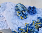 Crocheted WHITE baby afghan with blue and yellow variegated yarn.  Matching hats & 2 pairs of booties