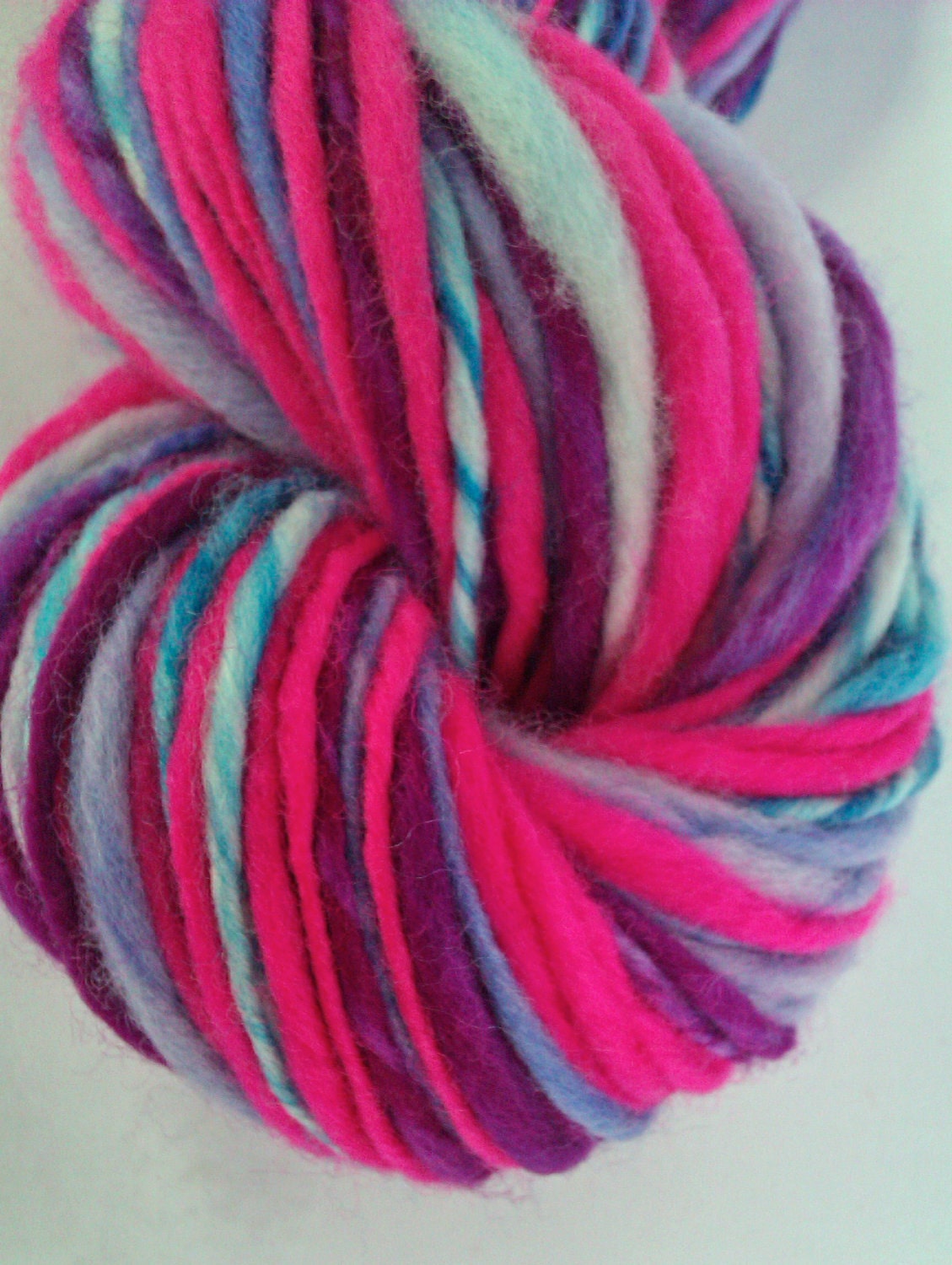 Self striping yarn in hot pink, lavender deep purple and blues -  Hand painted, hand spun art yarn. Pure Australian wool.