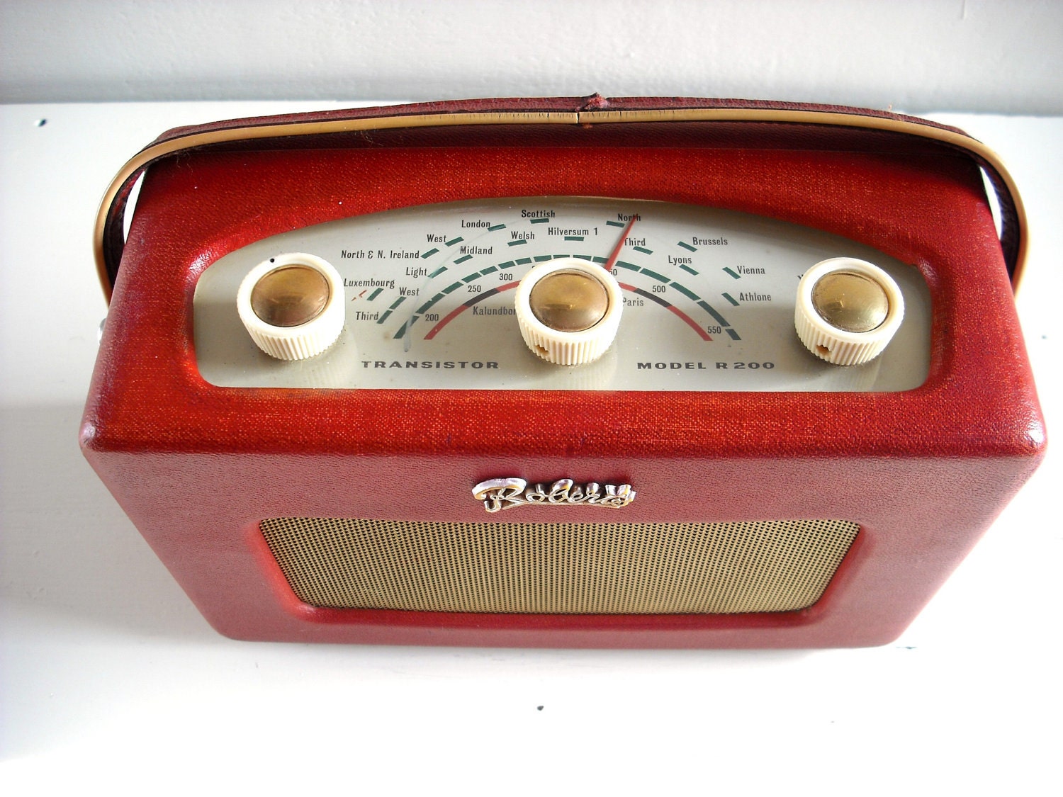 1960's Collectible Roberts R200 Transistor Radio in red. Leather-covered teak case. English early 60's vintage. Fully working