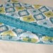 Baby Blanket in Bohemian Ikat Diamond Teal by Annette Tatum with Teal Minky Dot Back - 30" x 34"