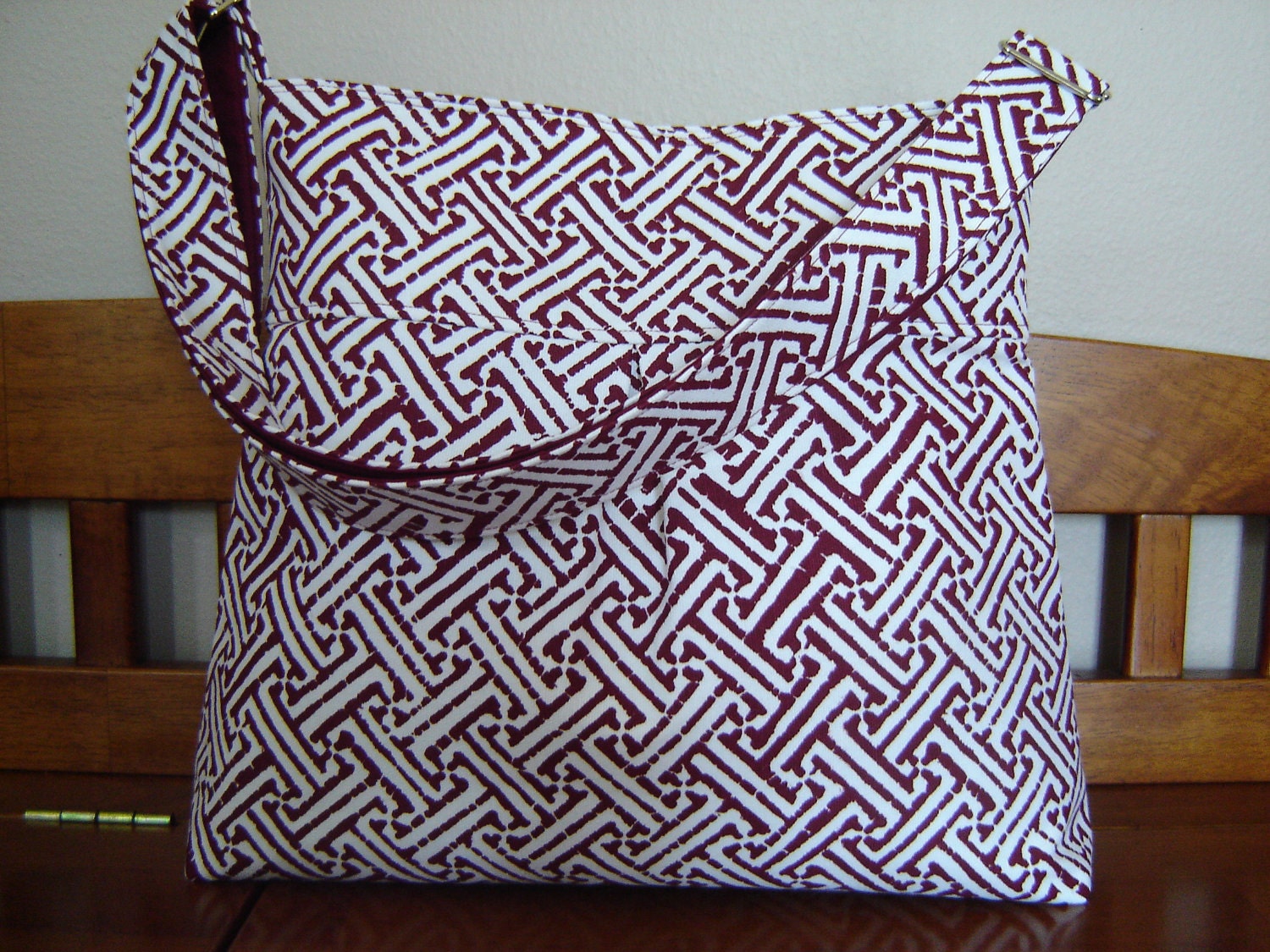 Cross body bag with adjustable strap red and white geometric print