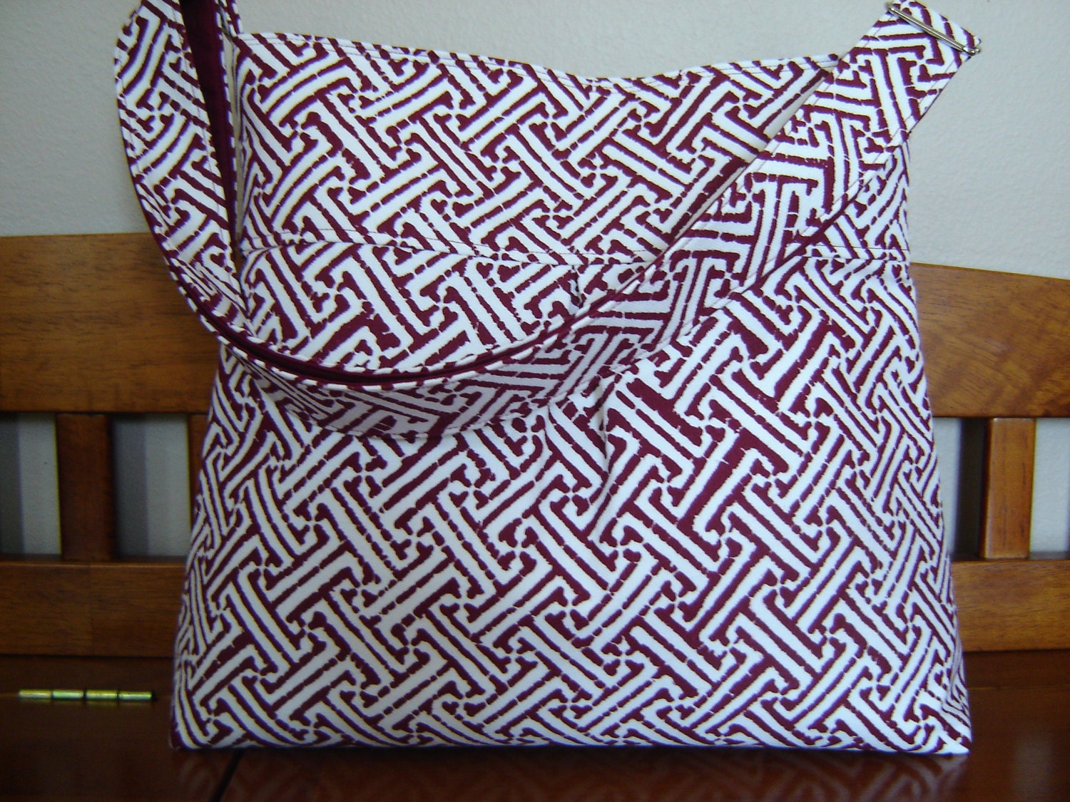Cross body bag with adjustable strap red and white geometric print