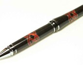 Ebony pen with Paduk and Aluminum Celtic Knot inlay, uses Parker refills.