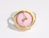 Swirl button ring in pastel yellow and pastel pink, silver toned wire wrapped, size 8