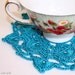 Two turquoise doilies, crocheted cotton with viscose. Coaster, placemat.