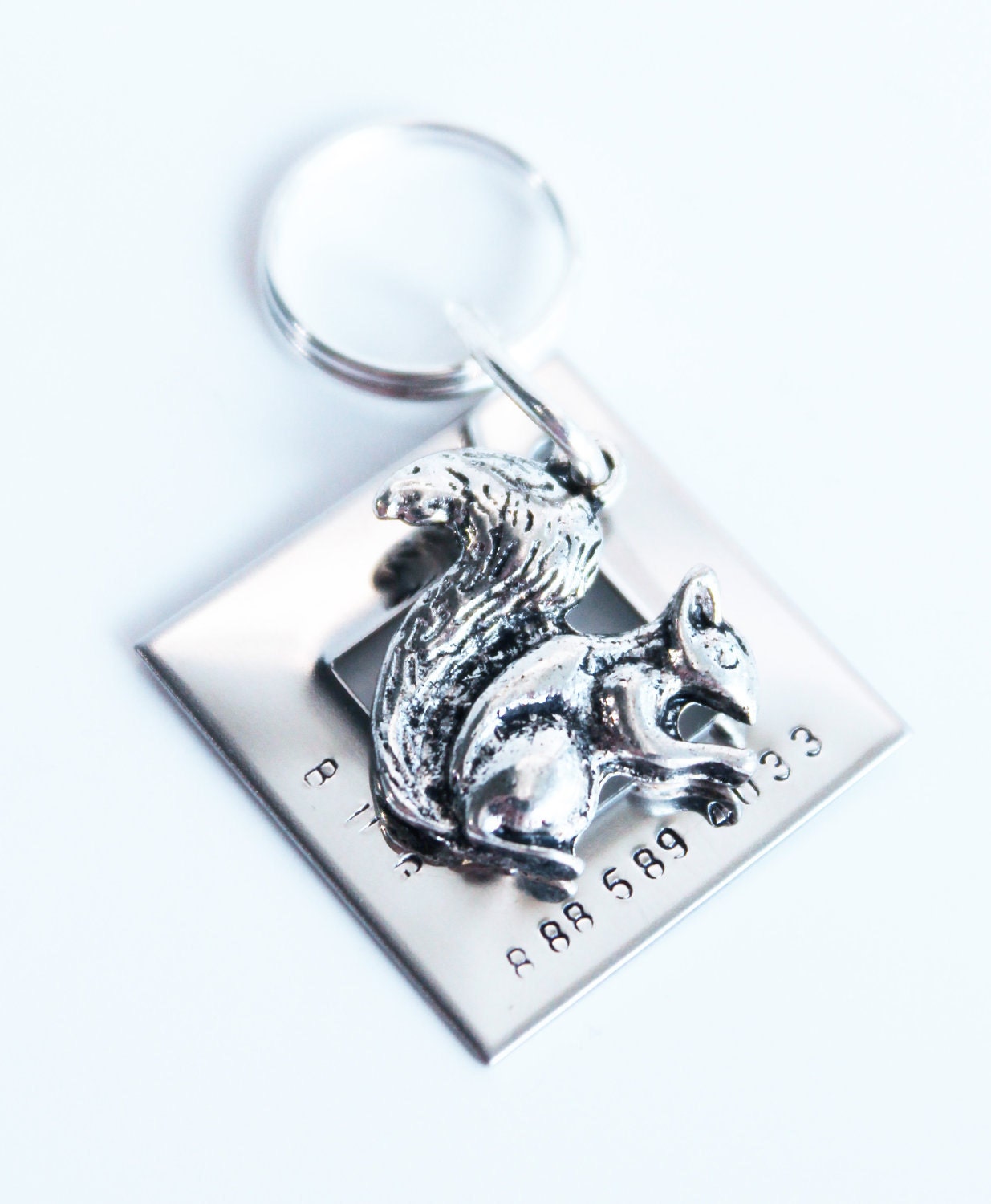 Metal name tag with squirrel charm