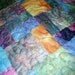 Throw size sofa quilt in many beautiful batik colors. RESERVED FOR LORRENE