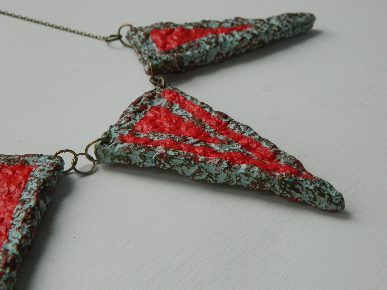 The Three Sisters triangle necklace- in ice green, dark olive and flame, hung on brass chain
