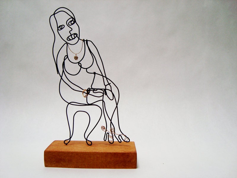 Beautiful Lady wire sculpture on wood base.  Sitting, waiting