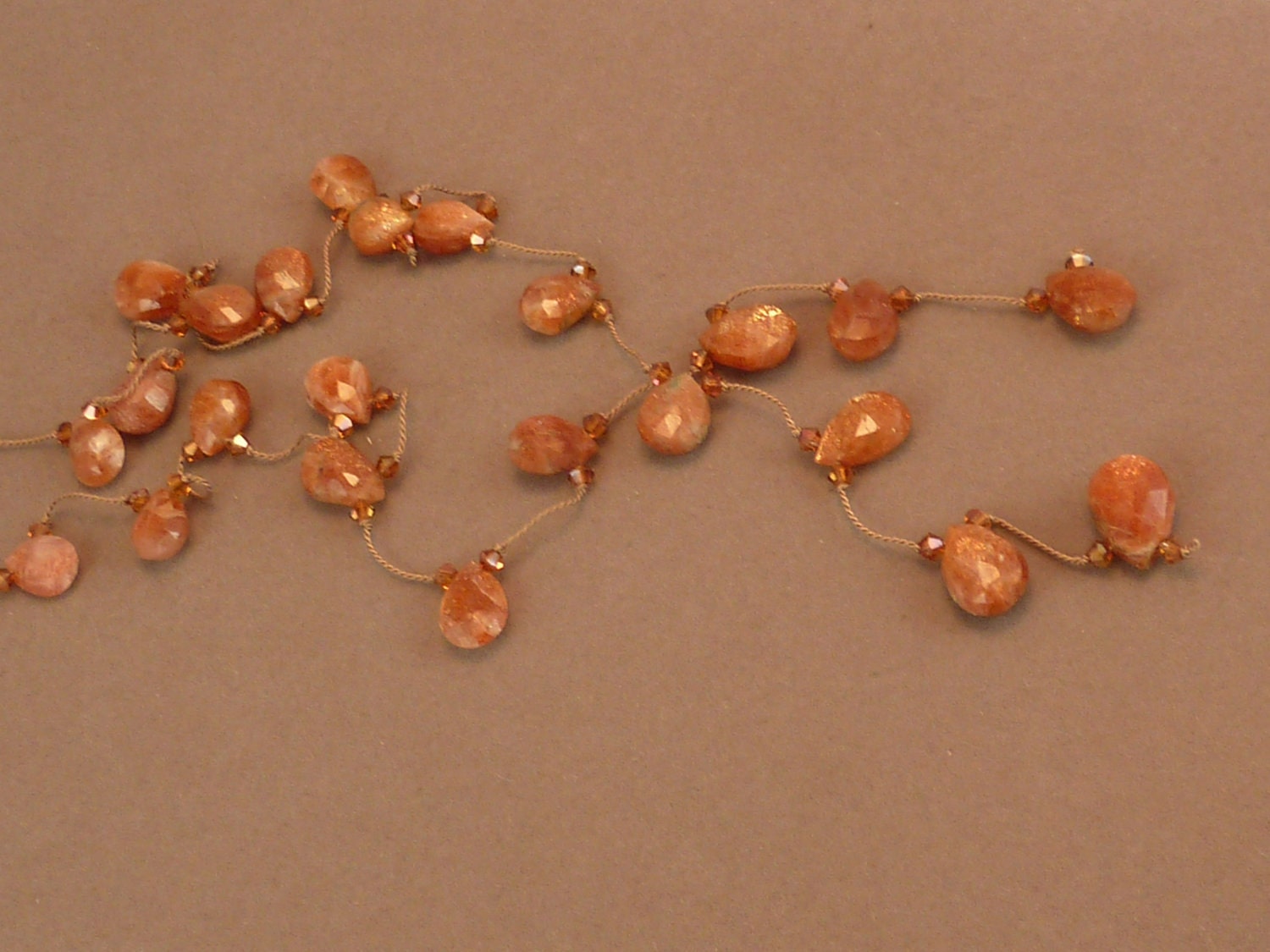 Faceted sunstone briolette hand knotted lariat with crystal