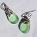 Wire wrapped earrings - Frosted bottle green glass & silver