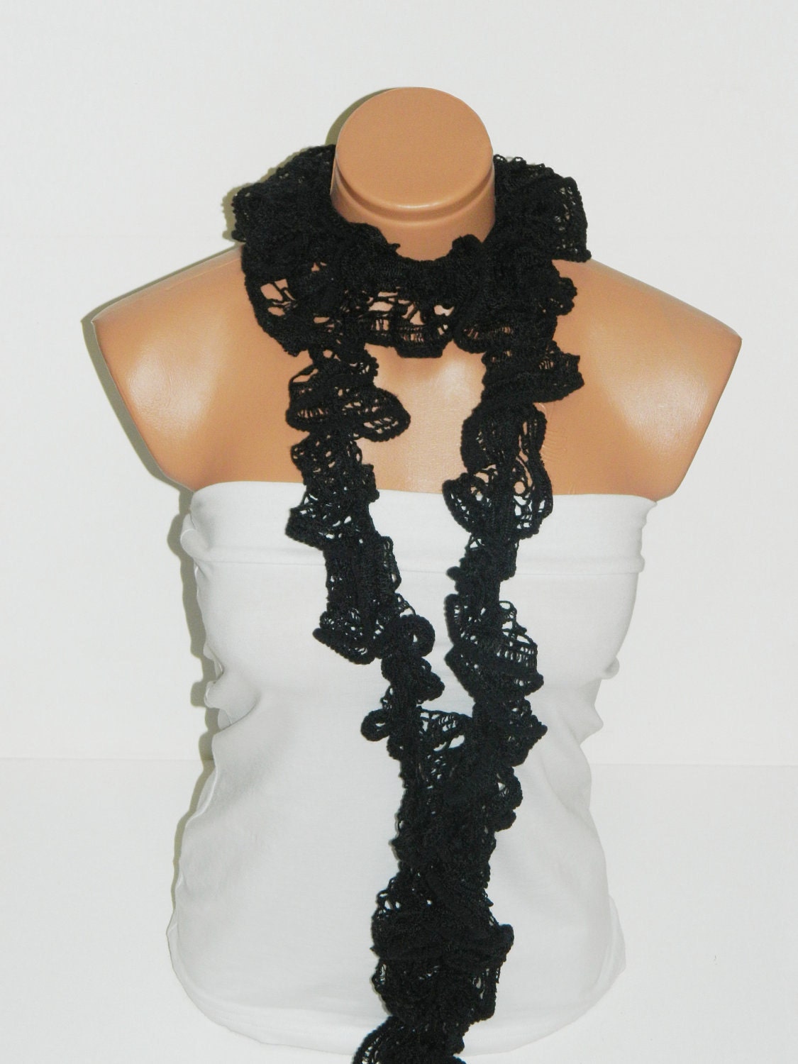 The scarf is knitted with black, soft yarn. Long scarf. Romantic. For her. HAND MADE.