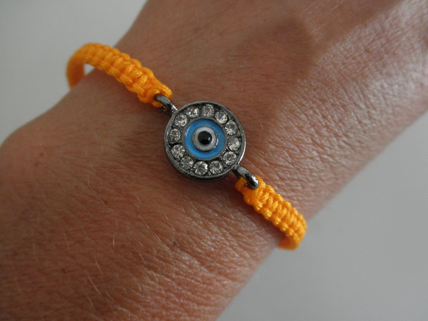 SALE rhinestone gunmetal evil eye bracelet on orange macrame