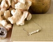 Simple and sweet, this lightly oxidized sterling silver chain necklace features a row of keishi and freshwater pearls.
