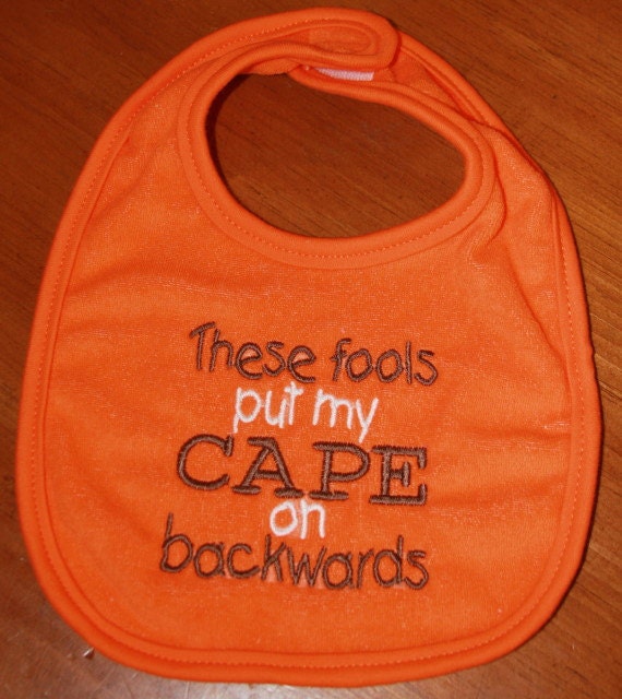 These fools put my CAPE on backwards on orange bib with brown and white writing