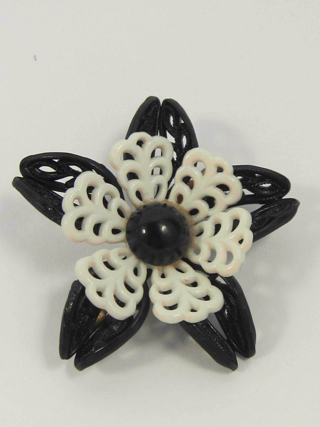 Black and white flower pin