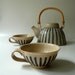 A Pair of Striped Teacups in Sand and Blue