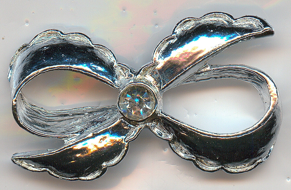 Vintage Bow Brooch, Made By Gerry's.  Silver Tone Bow with a Clear Rhinestone Center
