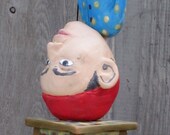 Upside down man (lidded vessel).