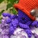 Maude, the purple octopus in a red hat amigurumi doll