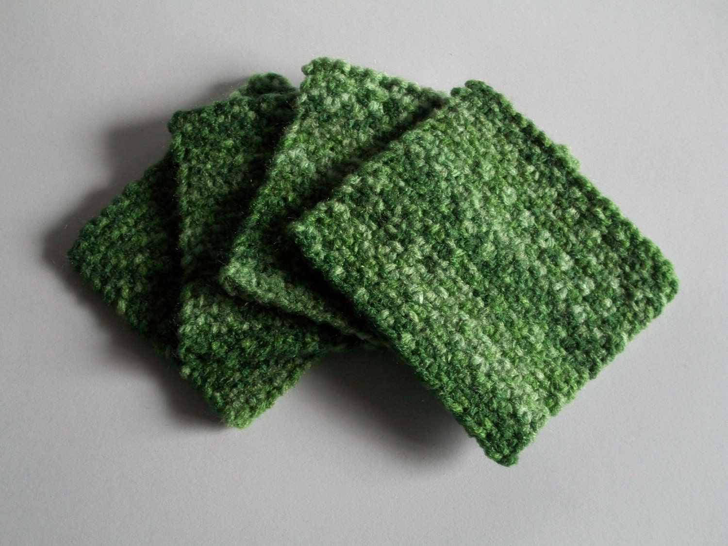 Green knitted coasters - set of 4