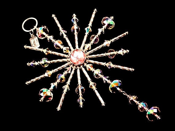 Star of Light Ornament is 6" x 4" and handcrafted with a pink center, Aurora Borealis crystals, Swarovski crystals, crystal twisted bugles