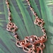 Copper Wire-wrapped Celtic Styled Necklace With Amethyst, Copper and Faceted Irridescent Beads.