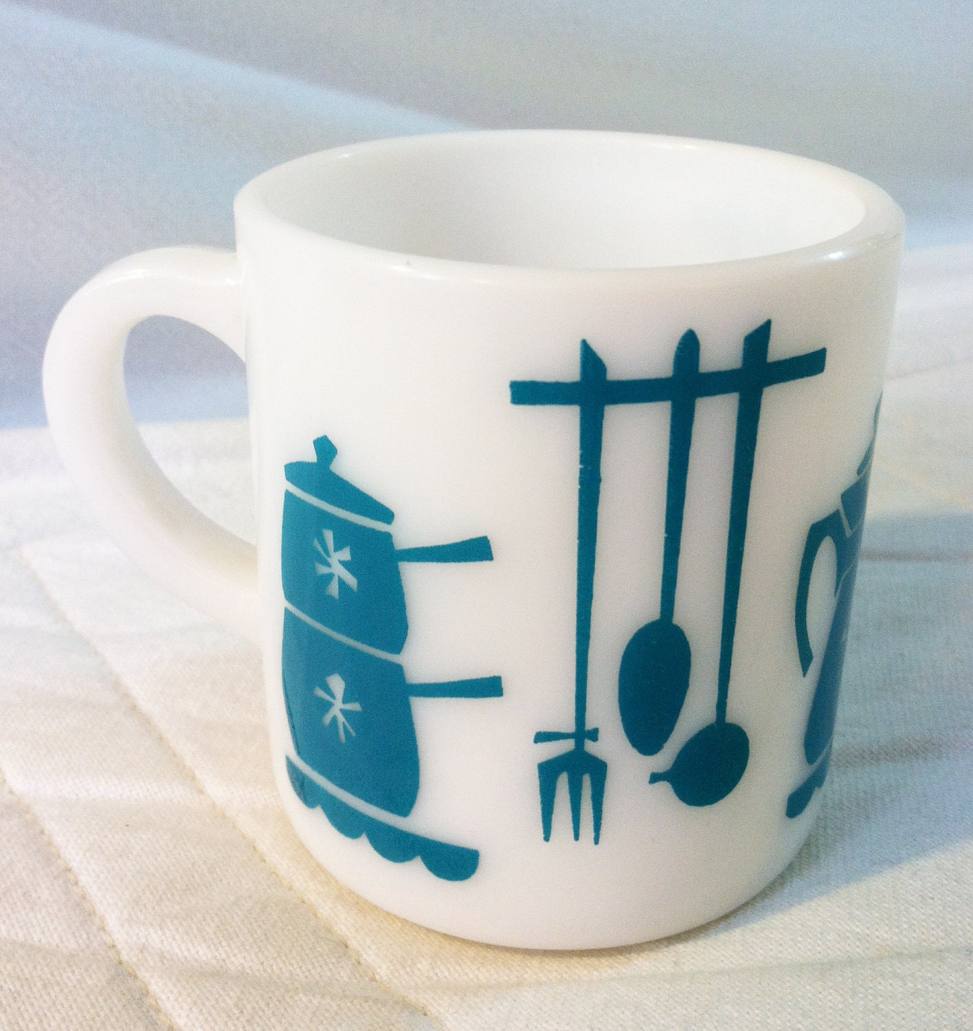 Vintage milk glass mug with teal design