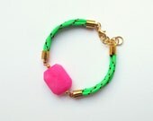Neon green bracelet with hot pink faceted gemstone