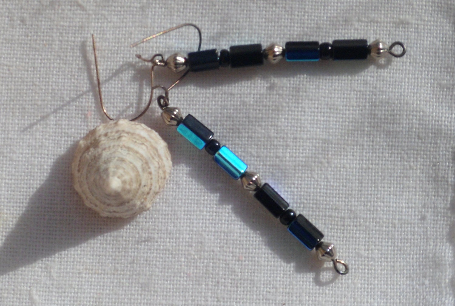 Vintage looking earrings dangling of blue beads and silver balls.