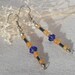 Dangling earrings of opaque yellow beads, hematite, vintage blue beads and silver balls