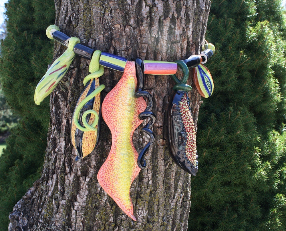 Tree Bling, orange, lime & black jewellery for your trees, handmade exotic, organic, ceramic baubles to decorate your tree trunks