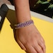 Leather like cord and chain braided bracelet, silver and purple.