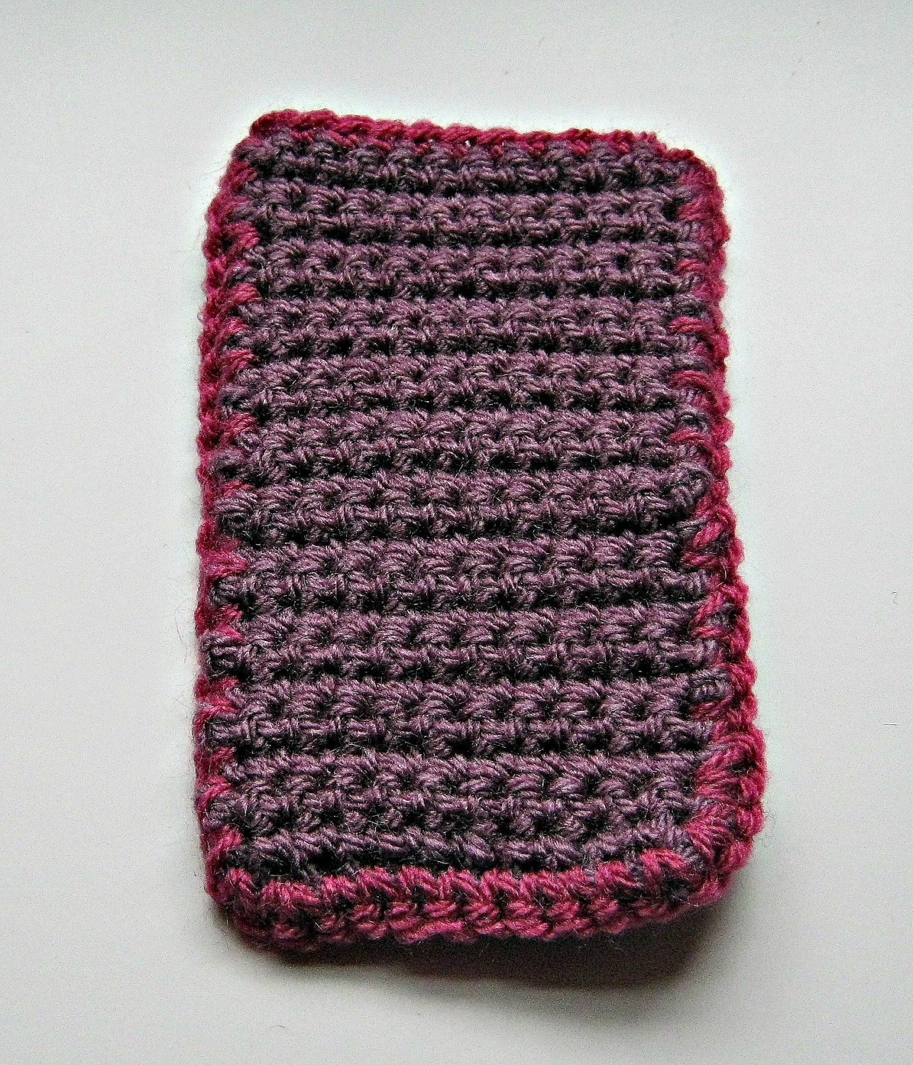 Crocheted iPod cover in plum with a dark pink trim