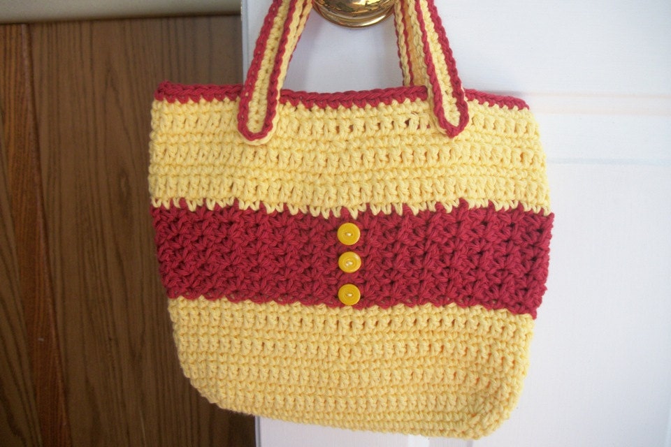 Crocheted tote bag of red and yellow cotton yarn with yellow button accents