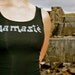 Namaste done in vintage looking silk screen on a black workout tank top with a yoga symbols sliced back