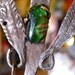 Peruvian Spoon Shawl Pin with Milagros Charms and Green Glass Bead - vintage hand-hammered silver brooch from 1920s
