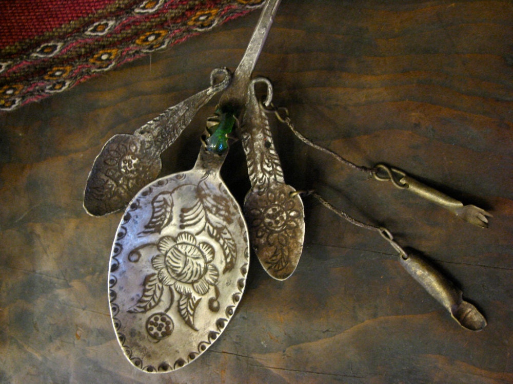 Peruvian Spoon Shawl Pin with Milagros Charms and Green Glass Bead - vintage hand-hammered silver brooch from 1920s