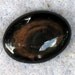 gold sheen obsidian cabochon 22mm x 30mm x 6mm at 5.2 grams