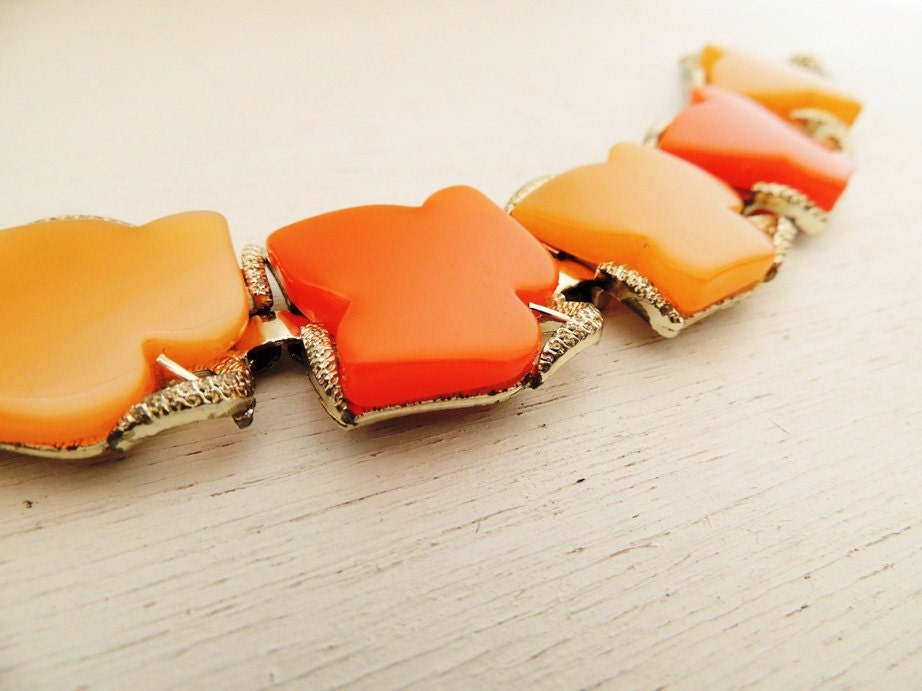 1960s lucite large leaf orange bracelet. SMOLDERING HUES.