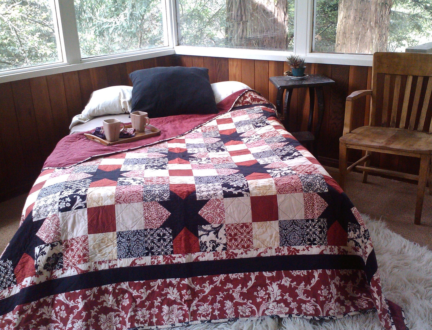 Queen size Sawtooth Star quilt in rich red, black, and creams.