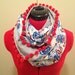 Infinity Circle Scarf with pom pom accents.