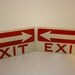 Pair of vintage 14in X 7in metal EXIT signs from the Zig Zag rolling paper/ Beechnut factory